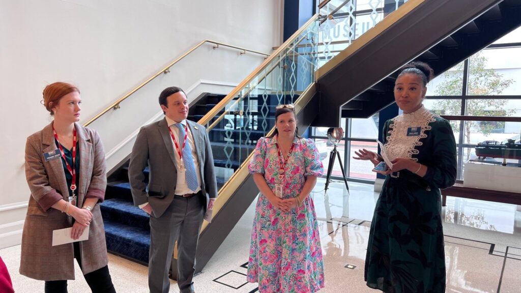 Group photo of museum personnel who arranged for the private group tour of the National WII Museum in New Orleans