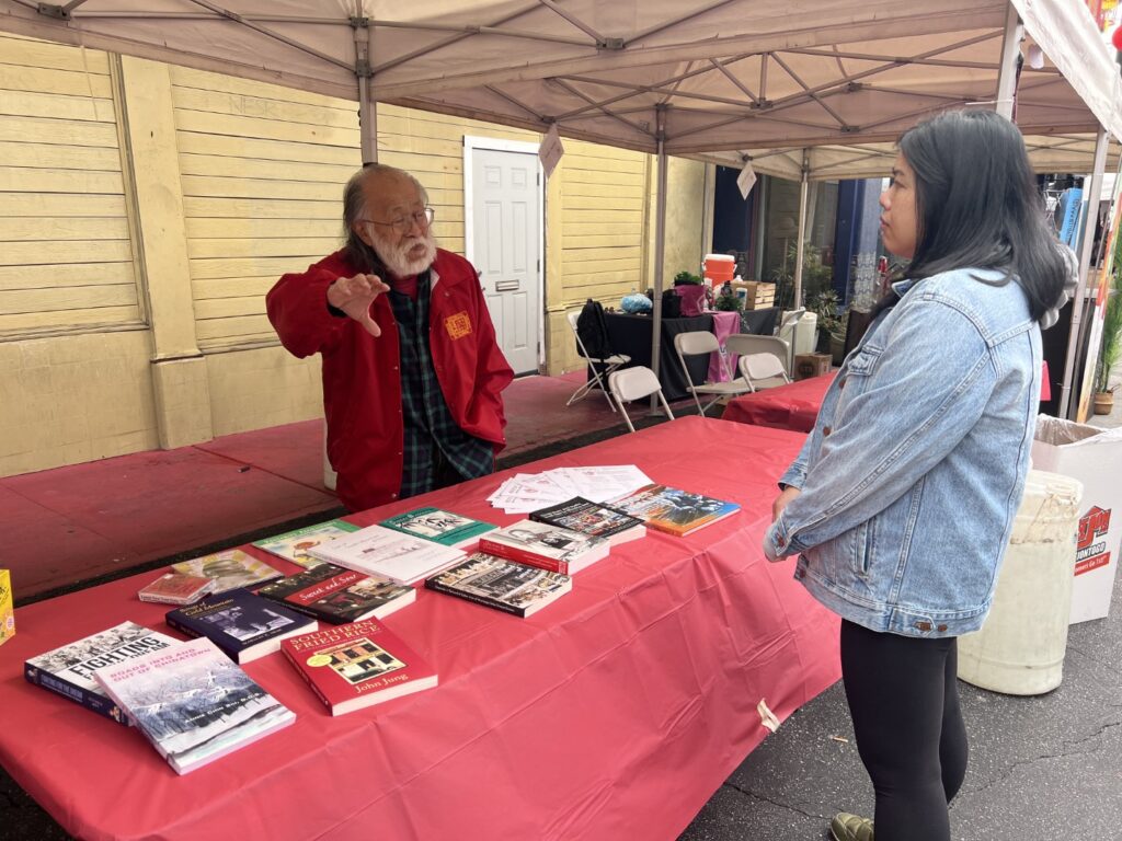 Past president Eugene Moy talking to board member Laureen Hom