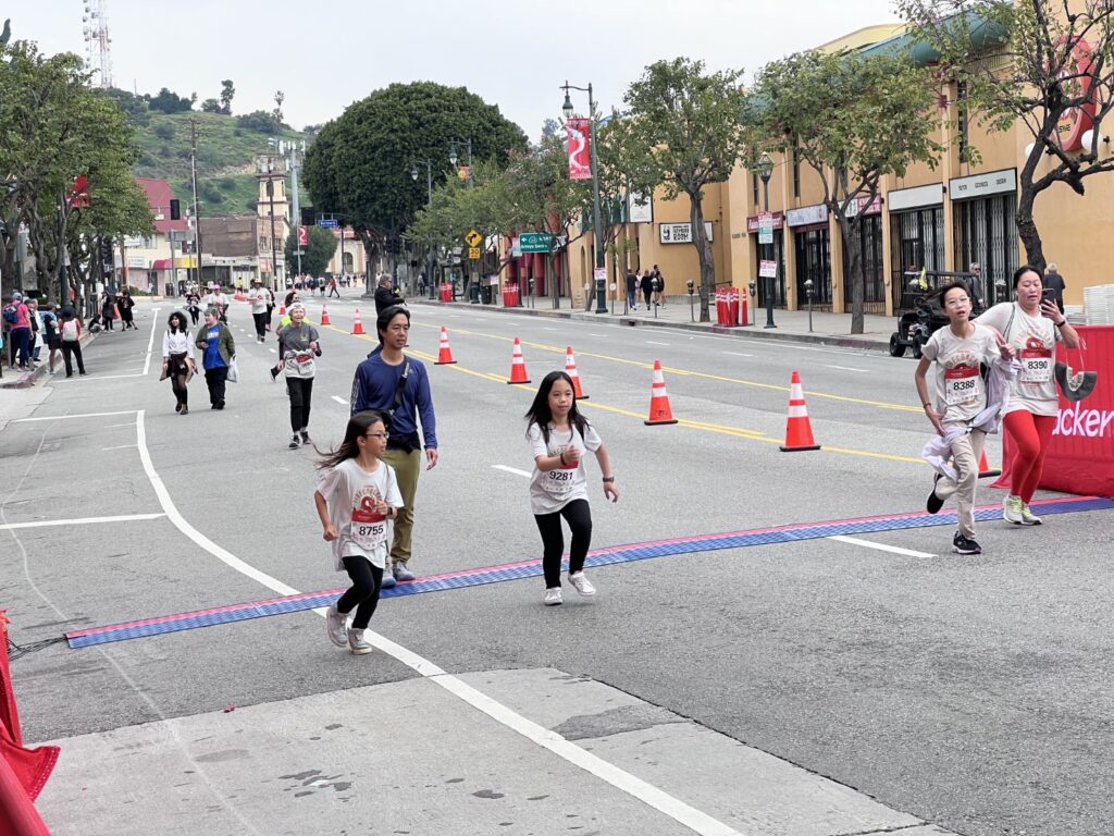 Runners approaching the finish line at the Firecracker Run