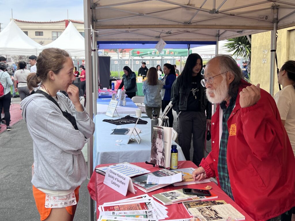 alking to visitor at CHSSC booth at Firecracker Run