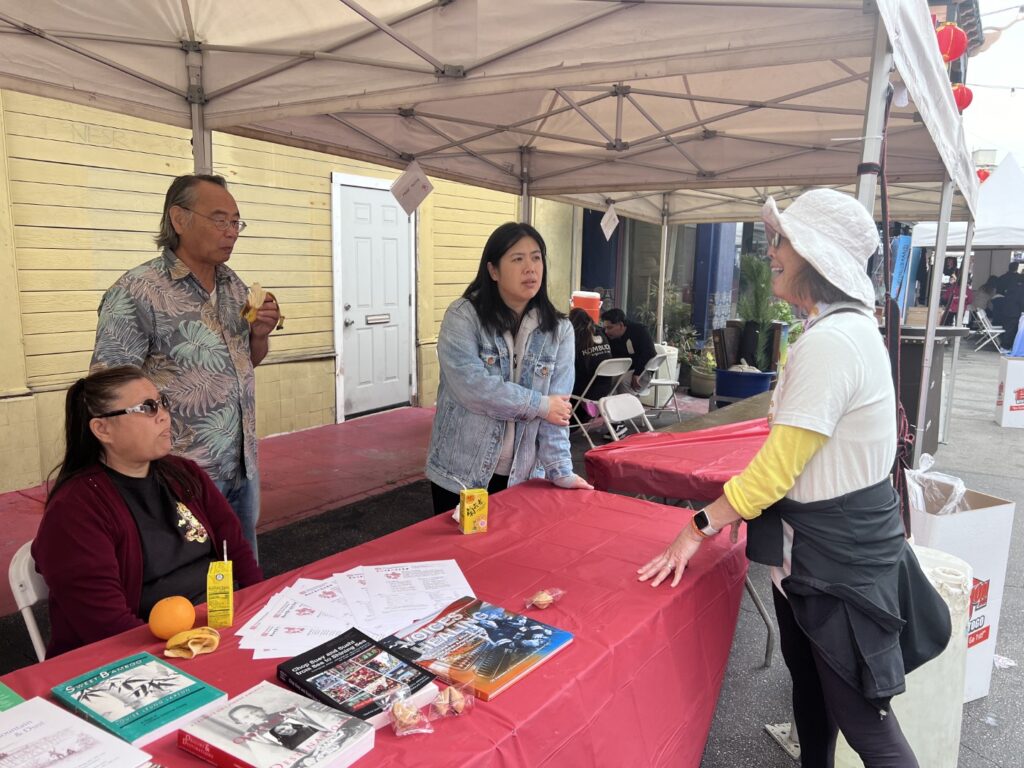 Talking to visitor at CHSSC booth at Firecracker Run