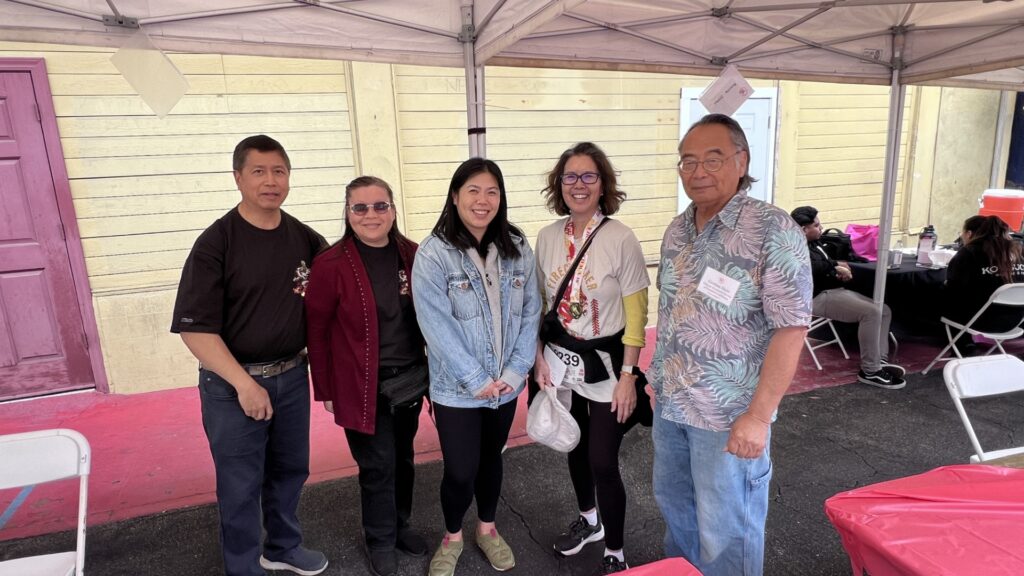 Group photo with visitor to CHSSC booth at Firecracker Run